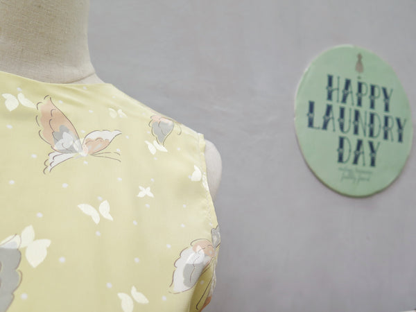 Hanamee | Vintage 1950s 1960s pastel yellow silky Dress with button back and butterfly print