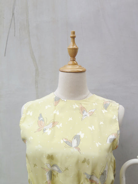 Hanamee | Vintage 1950s 1960s pastel yellow silky Dress with button back and butterfly print