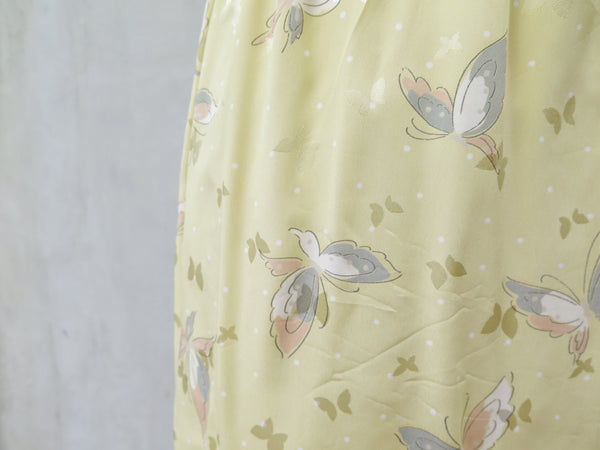 Hanamee | Vintage 1950s 1960s pastel yellow silky Dress with button back and butterfly print
