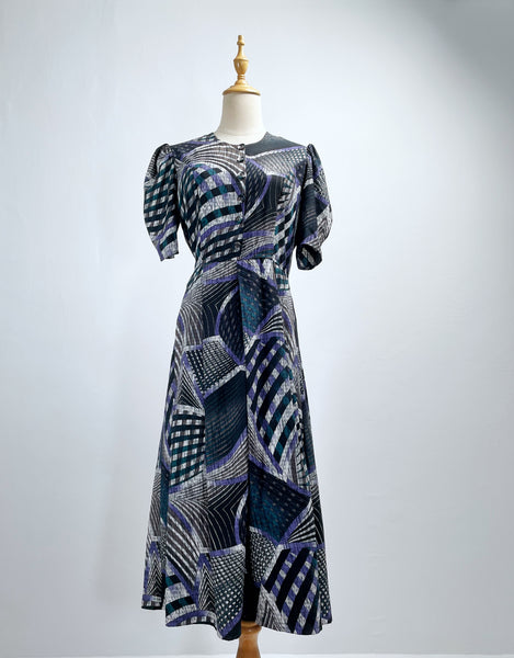Noelle | Vintage 1970s geometric swirl print dress with matching fabric buttons