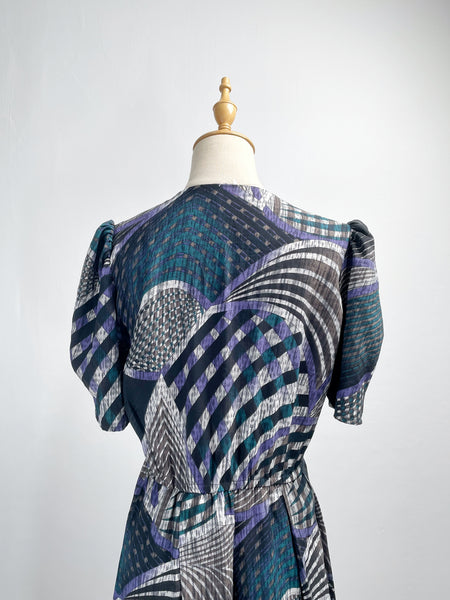 Noelle | Vintage 1970s geometric swirl print dress with matching fabric buttons