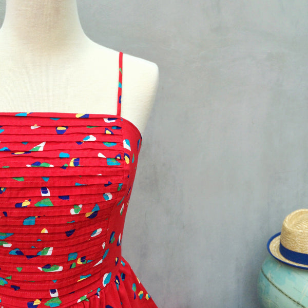 Summer Hooray! | Vintage 1950s Red confetti graphic print Pleated bodice Full circle swing skirt Strappy Dress