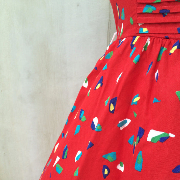 Summer Hooray! | Vintage 1950s Red confetti graphic print Pleated bodice Full circle swing skirt Strappy Dress
